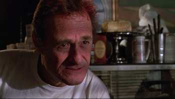 Movie still from “Twilight Zone: The Movie” (1983), directed by Steven Spielberg – A person wearing a white t - shirt; Close Up shot, Low angle