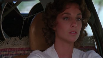 Movie still from “Twilight Zone: The Movie” (1983), directed by Steven Spielberg – A person sitting in a car; Close Up shot, Over the shoulder angle