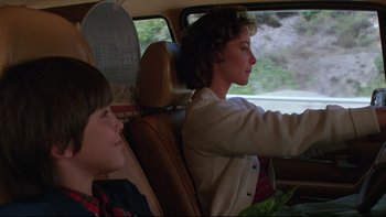 Movie still from “Twilight Zone: The Movie” (1983), directed by Steven Spielberg – A woman and a child in a car; Medium shot, Over the shoulder angle