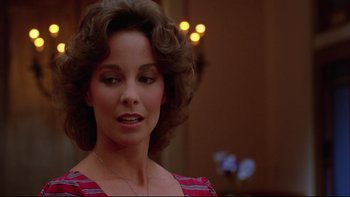 Movie still from “Twilight Zone: The Movie” (1983), directed by Steven Spielberg – A person wearing a dress; Close Up shot, Over the shoulder angle