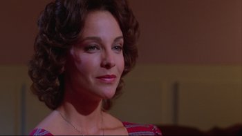 Movie still from “Twilight Zone: The Movie” (1983), directed by Steven Spielberg – A person wearing a necklace; Close Up shot, Low angle