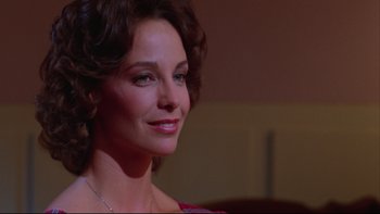 Movie still from “Twilight Zone: The Movie” (1983), directed by Steven Spielberg – A person wearing a necklace; Close Up shot, Low angle
