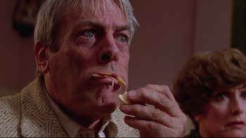 Movie still from “Twilight Zone: The Movie” (1983), directed by Steven Spielberg – An older man is eating a piece of food; Close Up shot, Low angle