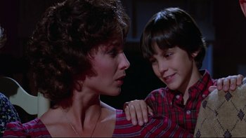 Movie still from “Twilight Zone: The Movie” (1983), directed by Steven Spielberg – A woman and a boy sitting next to each other; Close Up shot, Over the shoulder angle