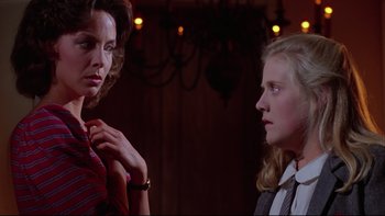 Movie still from “Twilight Zone: The Movie” (1983), directed by Steven Spielberg – A woman standing next to another woman in a room; Close Up shot, Low angle