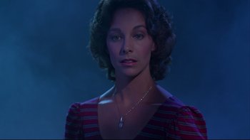 Movie still from “Twilight Zone: The Movie” (1983), directed by Steven Spielberg – A person wearing a necklace; Close Up shot, Low angle