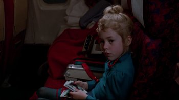 Movie still from “Twilight Zone: The Movie” (1983), directed by Steven Spielberg – A little girl sitting in a chair holding a nintendo wii game controller; Close Up shot, High angle