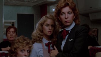 Movie still from “Twilight Zone: The Movie” (1983), directed by Steven Spielberg – A group of women standing next to each other in a room; Medium shot, Low angle
