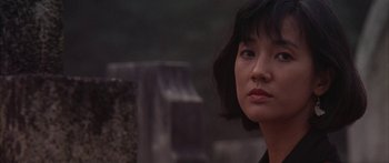 Movie still from “Twin Dragons” (1992), directed by Ringo Lam – A person with short black hair; Close Up shot, Over the shoulder angle