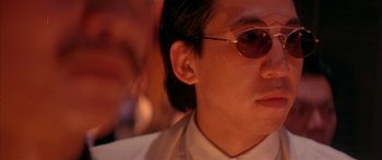 Movie still from “Twin Dragons” (1992), directed by Ringo Lam – A person wearing sunglasses; Close Up shot, Low angle