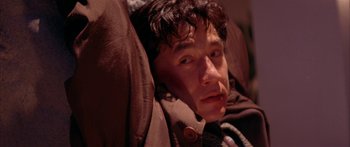 Movie still from “Twin Dragons” (1992), directed by Ringo Lam – A person laying in a chair; Close Up shot, High angle