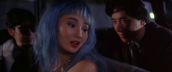 Movie still from “Twin Dragons” (1992), directed by Ringo Lam – A woman with blue hair is looking at a man; Close Up shot, Over the shoulder angle