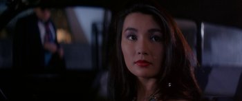Movie still from “Twin Dragons” (1992), directed by Ringo Lam – A person with long dark hair; Close Up shot, Over the shoulder angle