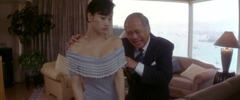 Movie still from “Twin Dragons” (1992), directed by Ringo Lam – An older man and a young woman in formal wear; Medium shot, Low angle