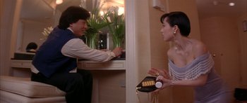 Movie still from “Twin Dragons” (1992), directed by Ringo Lam – A man and a woman are talking in a room; Medium shot, Low angle