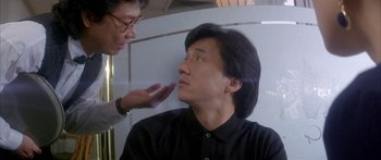 Movie still from “Twin Dragons” (1992), directed by Ringo Lam – A man with glasses is looking at another man with glasses; Close Up shot, Over the shoulder angle