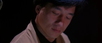 Movie still from “Twin Dragons” (1992), directed by Ringo Lam – A person with his eyes closed; Close Up shot, Low angle
