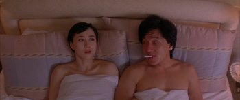 Movie still from “Twin Dragons” (1992), directed by Ringo Lam – A man and a woman laying in a bed together; Medium shot, High angle