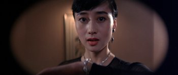 Movie still from “Twin Dragons” (1992), directed by Ringo Lam – A person wearing a black shirt; Close Up shot, Low angle