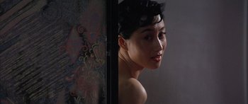 Movie still from “Twin Dragons” (1992), directed by Ringo Lam – A young woman is standing in front of a mirror; Close Up shot, Over the shoulder angle