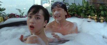 Movie still from “Twin Dragons” (1992), directed by Ringo Lam – A man and a woman in a bath tub; Close Up shot, Low angle