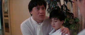 Movie still from “Twin Dragons” (1992), directed by Ringo Lam – A man and a woman sitting next to each other; Close Up shot, Low angle