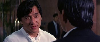 Movie still from “Twin Dragons” (1992), directed by Ringo Lam – A man in a white shirt is talking to another man in a black suit; Close Up shot, Over the shoulder angle