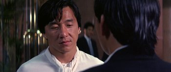 Movie still from “Twin Dragons” (1992), directed by Ringo Lam – A man in a white shirt is talking to another man in a black suit; Close Up shot, Over the shoulder angle