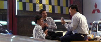 Movie still from “Twin Dragons” (1992), directed by Ringo Lam – A group of men sitting on the ground playing cards; Medium shot, Low angle