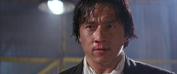 Movie still from “Twin Dragons” (1992), directed by Ringo Lam – A person wearing a suit and tie; Close Up shot, Low angle