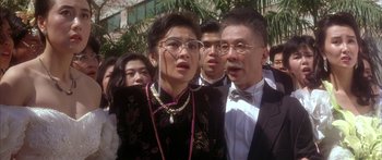 Movie still from “Twin Dragons” (1992), directed by Ringo Lam – A group of people standing next to each other; Close Up shot, Low angle