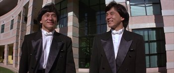 Movie still from “Twin Dragons” (1992), directed by Ringo Lam – A couple of men standing next to each other in tuxedos; Medium shot, Low angle