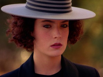 Movie still from “Twin Peaks” (1990), created by David Lynch – A person wearing a hat; Close Up shot, Over the shoulder angle