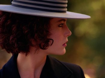 Movie still from “Twin Peaks” (1990), created by David Lynch – A person wearing a hat; Close Up shot, Over the shoulder angle