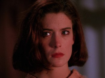 Movie still from “Twin Peaks” (1990), created by David Lynch – A person with short brown hair; Close Up shot, Low angle