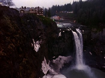 Movie still from “Twin Peaks” (1990), created by David Lynch – A view of a waterfall from the side of a cliff; Extreme Wide shot, High angle