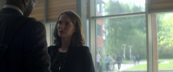 Movie still from “Annihilation” (2018), directed by Alex Garland – A woman standing in front of a large window; Medium shot, Over the shoulder angle