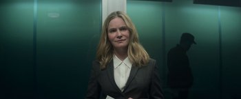 Movie still from “Annihilation” (2018), directed by Alex Garland – A woman in a suit standing next to an elevator; Close Up shot, Low angle