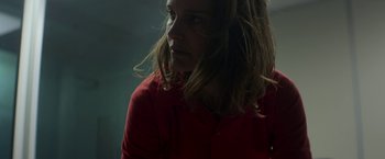 Movie still from “Annihilation” (2018), directed by Alex Garland – A woman in a red shirt is looking to her left; Close Up shot, Low angle