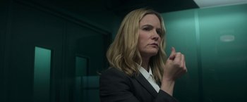 Movie still from “Annihilation” (2018), directed by Alex Garland – A woman in a black suit clapping her hands; Close Up shot, Low angle