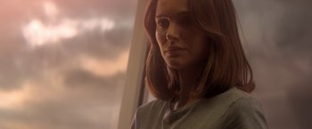 Movie still from “Annihilation” (2018), directed by Alex Garland – A person with long red hair; Close Up shot, Low angle