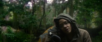 Movie still from “Annihilation” (2018), directed by Alex Garland – A woman with a camera in the woods; Close Up shot, Low angle