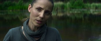 Movie still from “Annihilation” (2018), directed by Alex Garland – A person wearing a scarf near a body of water; Close Up shot, Over the shoulder angle