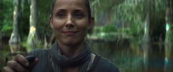 Movie still from “Annihilation” (2018), directed by Alex Garland – A person wearing a scarf near a body of water; Close Up shot, Over the shoulder angle