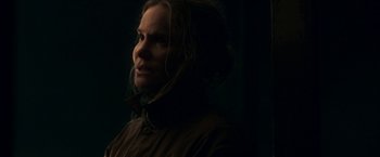 Movie still from “Annihilation” (2018), directed by Alex Garland – A woman in a brown jacket looking to her left; Close Up shot, Low angle