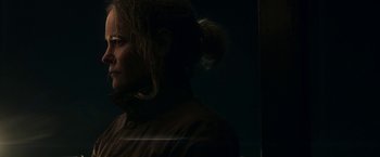Movie still from “Annihilation” (2018), directed by Alex Garland – A woman is standing in a dark room; Close Up shot, Low angle