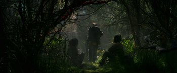 Movie still from “Annihilation” (2018), directed by Alex Garland – A group of people sitting in the woods; Wide shot, Low angle