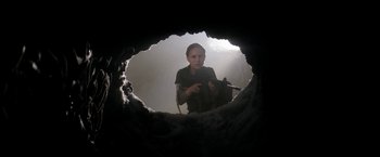 Movie still from “Annihilation” (2018), directed by Alex Garland – A woman holding a gun in a hole in the ground; Medium shot, Low angle