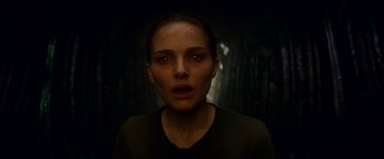 Movie still from “Annihilation” (2018), directed by Alex Garland – A person in a dark room; Close Up shot, Overhead angle