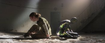 Movie still from “Annihilation” (2018), directed by Alex Garland – A woman sitting on the ground next to another woman; Wide shot, Over the shoulder angle